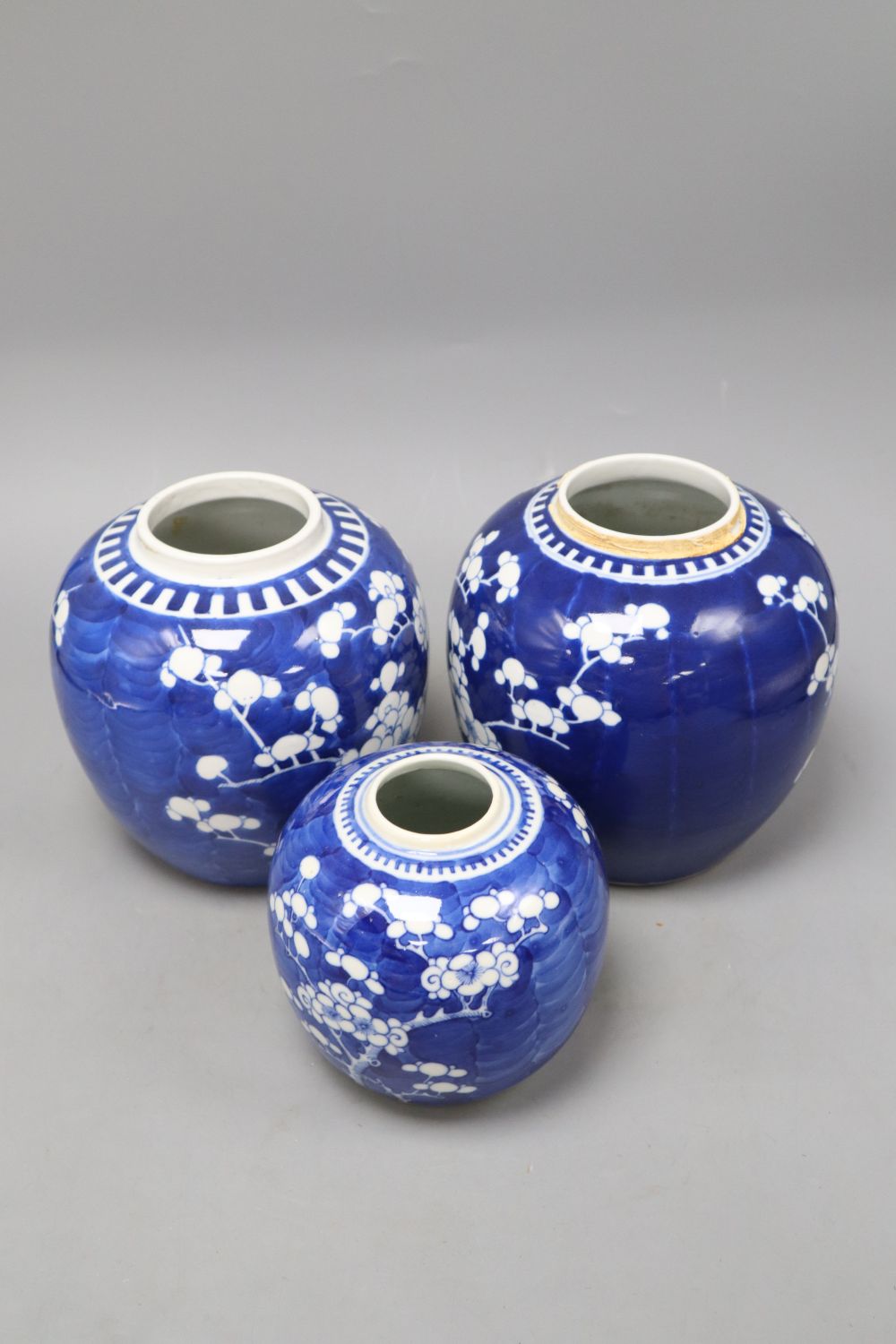 Three Chinese blue and white prunus jars, one with apocryphal kangxi mark